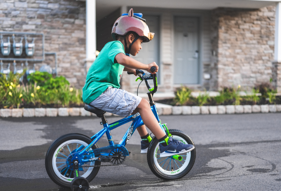 Kid on a bike wearing a helmet